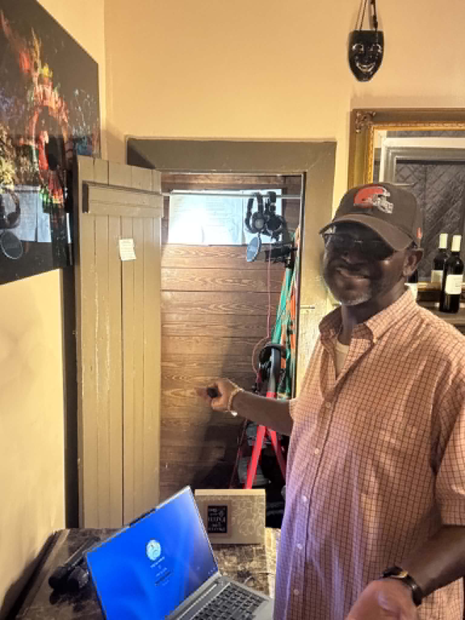 Raphael Ashanti gesturing toward the recording booth
